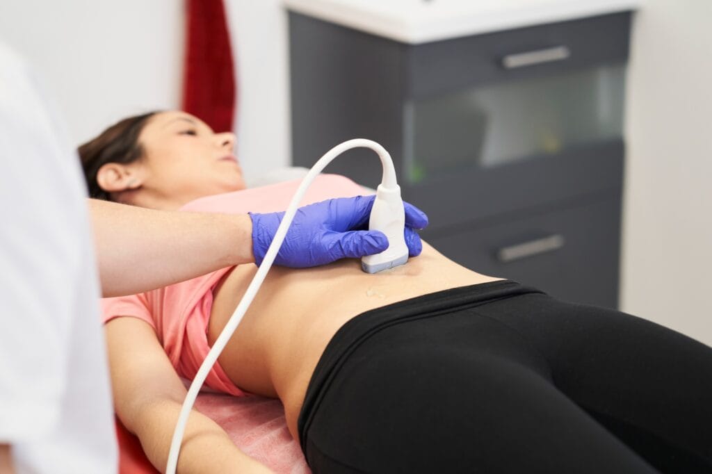 a physiotherapist performing an ultrasound scan for pelvic floor treatment