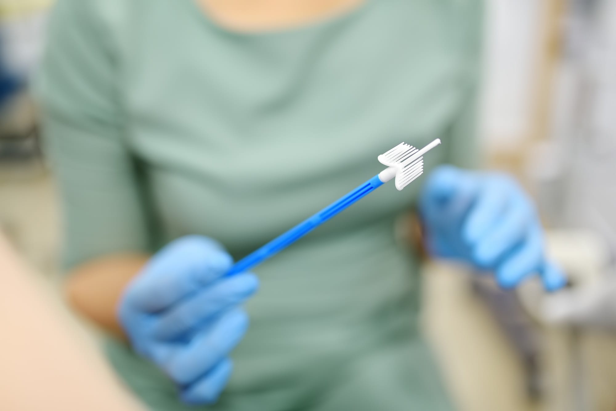 Gynecologist examines a patient takes a smear from a woman cervix.