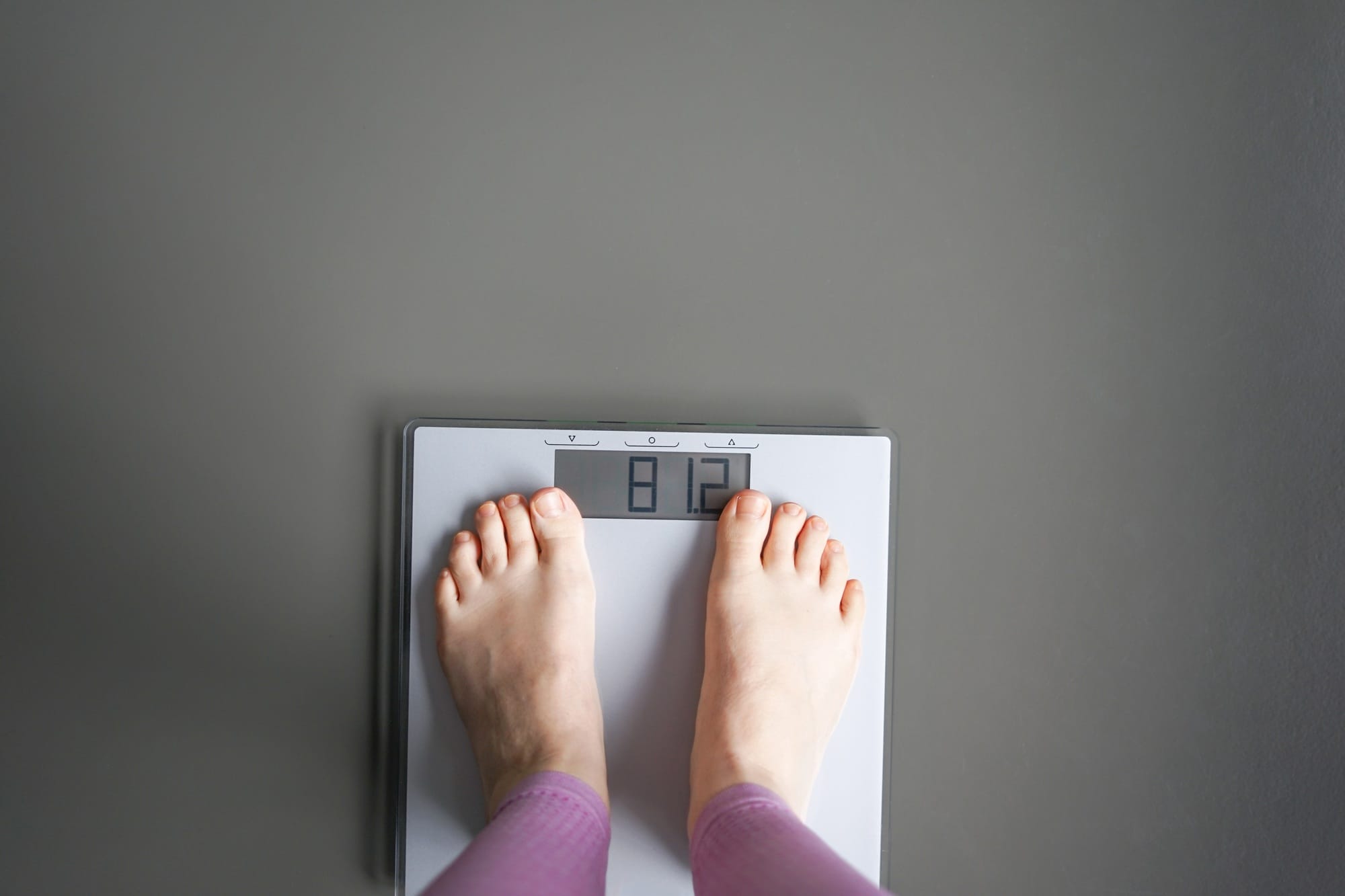 Woman watching her weight . Weight loss. Healthy weight.